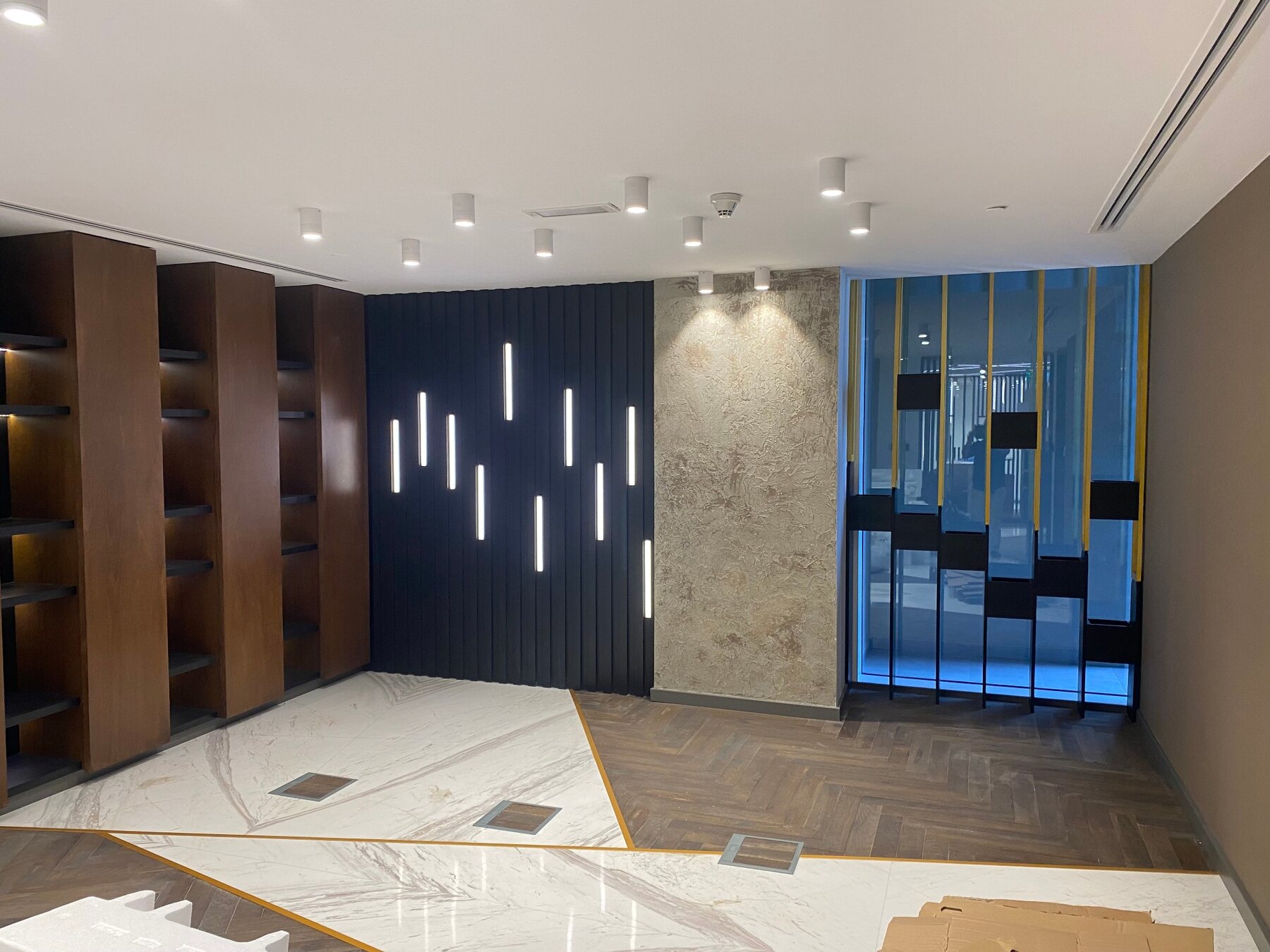 Completed commercial interior with decorative wall finishes and ceiling lights