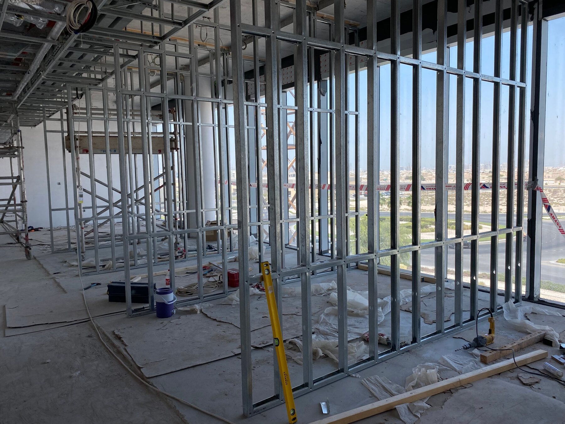 Steel framing for commercial gypsum partitions beside full-height windows